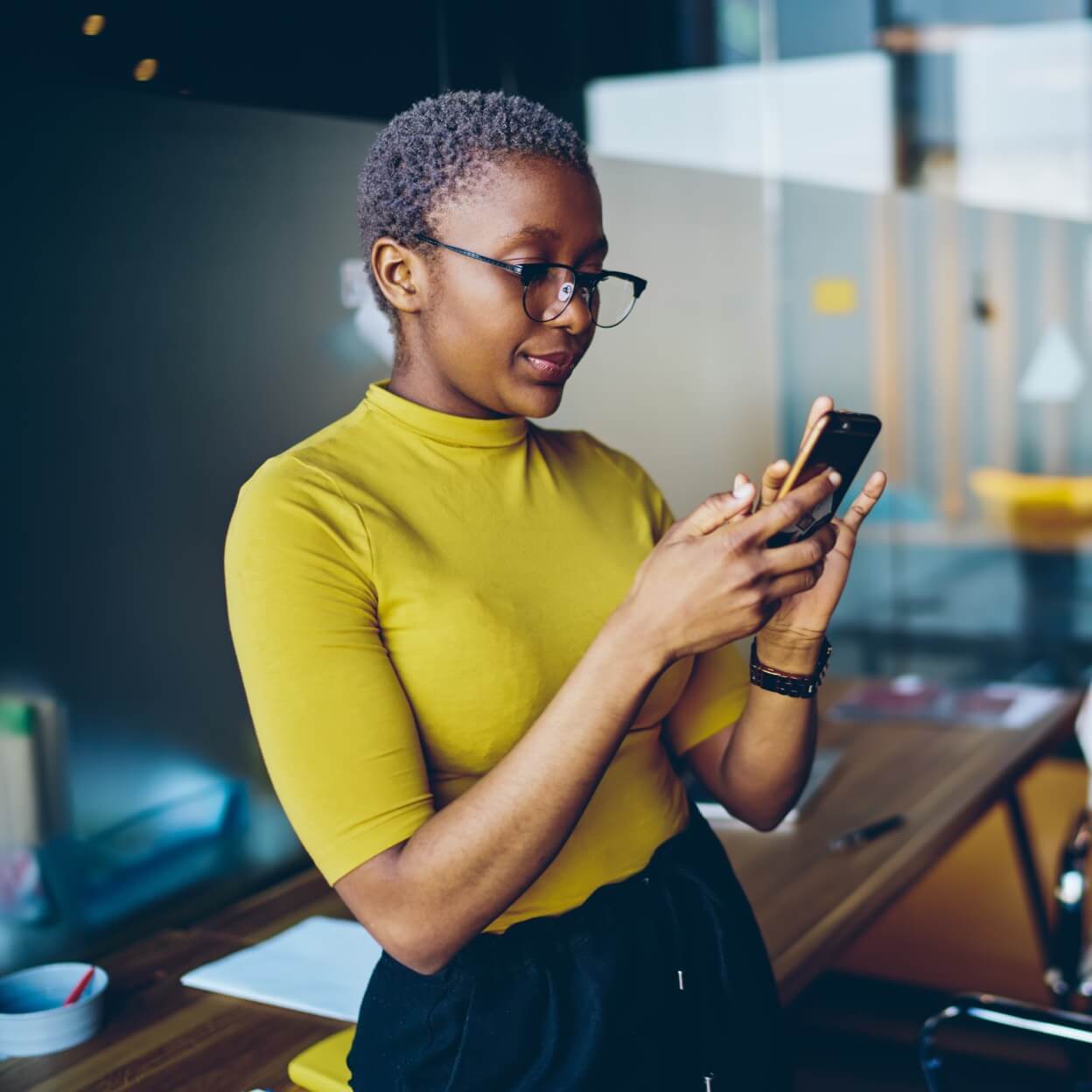 Woman looking at phone in an office